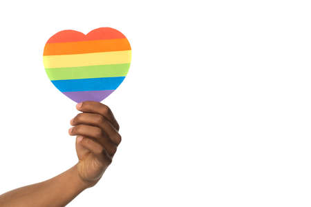 hand of african american holding rainbow colors paper heart isolated on whiteの写真素材