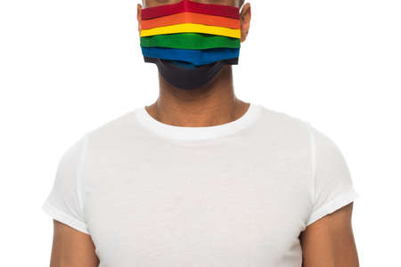 partial view of african american man in white t-shirt and lgbt colors medical mask isolated on whiteの写真素材