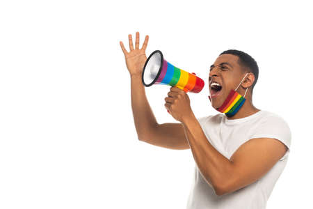 african american man with medical mask in lgbt colors screaming in loudspeaker isolated on whiteの写真素材