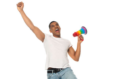 excited african american man showing win gesture while holding lgbt colors megaphone isolated on whiteの写真素材