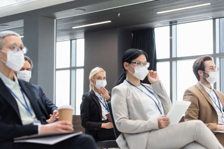 interracial business people in medical mask on business conferenceの写真素材