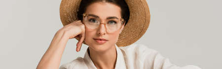 young woman in straw hat and glasses isolated on white, bannerの写真素材