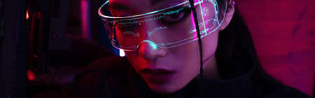 brunette asian woman with artificial scar holding gun and looking at camera, bannerの写真素材