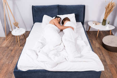 Young couple sleeping in bedroom
