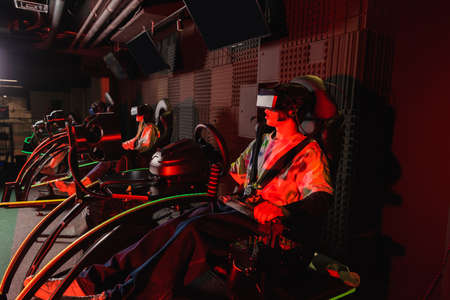 teenage gamers racing in car simulators in vr play zone
