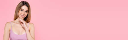 Young woman in top of swimsuit isolated on pink, bannerの写真素材