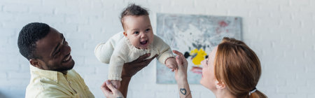 multiethnic parents having fun with cheerful baby girl, banner