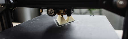 close up view of 3D printer creating plastic model on blurred background, bannerの写真素材