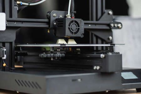 close up view of 3D printer creating plastic model on blurred backgroundの写真素材