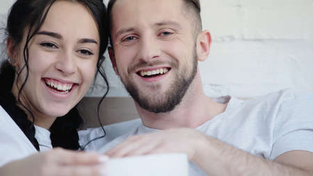 happy couple laughing while watching comedy movie