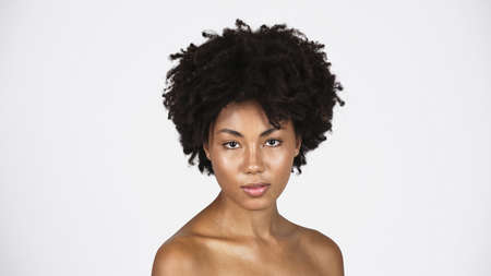 African american woman with perfect skin looking at camera isolated on grayの写真素材