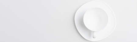 top view of empty cup and saucer isolated on white, bannerの写真素材