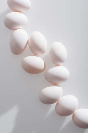 top view of organic eggs in shell on white backgroundの写真素材