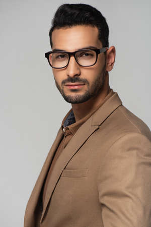 Bearded muslim businessman looking at camera isolated on grayの写真素材