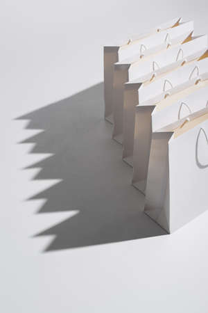 high angle view of shopping bags with purchases on whiteの写真素材