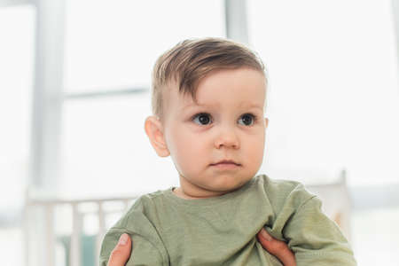 Mother holding toddler son at home