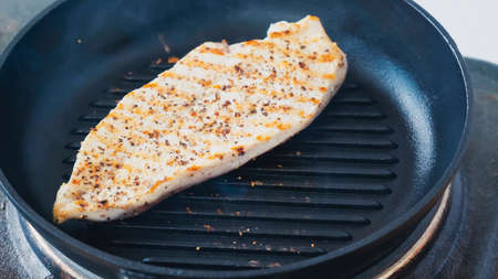 close up of spiced chicken fillet on grill pan