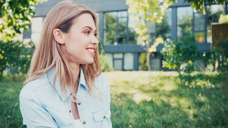pretty young woman smiling while looking away outside