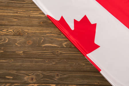 top view of canadian flag on wooden surfaceの写真素材