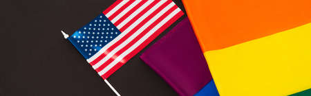high angle view of american and lgbt flags isolated on black, bannerの写真素材
