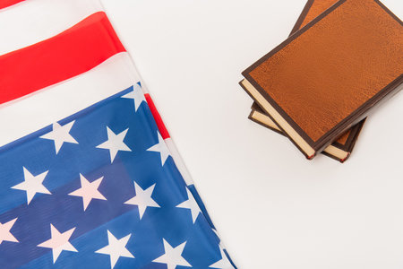 top view of american flag near books isolated on white