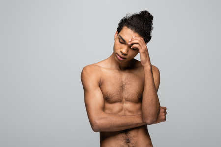 shirtless african american man touching forehead isolated on gray, beauty concept