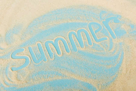 top view of summer lettering on sand and blue surface