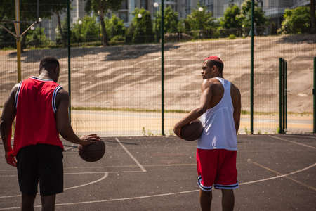 African american sportsmen with basketball balls on outdoor playgroundの写真素材