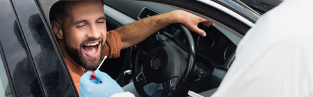 Medical worker holding pcr test near driver with open mouth in car, bannerの写真素材