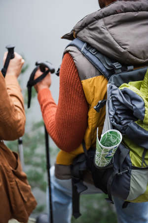 map in backpack of man standing near womanの写真素材