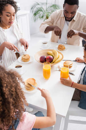 african american family eating pancakes for breakfast
