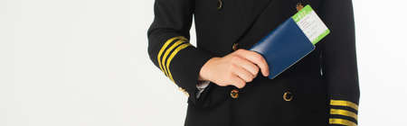 Cropped view of aviator holding passport and air ticket isolated on white, banner