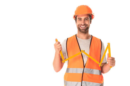 Smiling builder holding tape measure isolated on whiteの写真素材