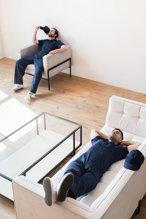 high angle view of movers resting in modern living room