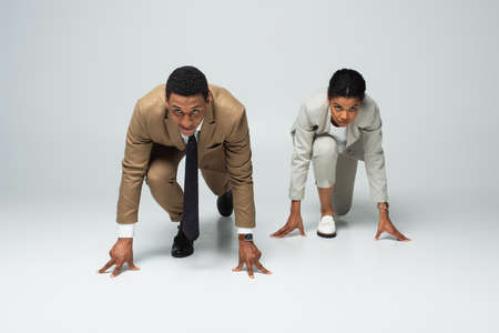 african american business people in starting pose before running on grayの写真素材