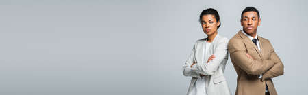 african american business people standing with crossed arms isolated on gray, bannerの写真素材