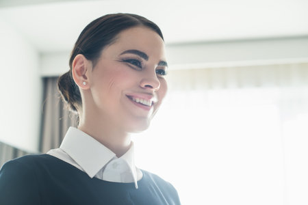 low angle view of happy maid smiling in room