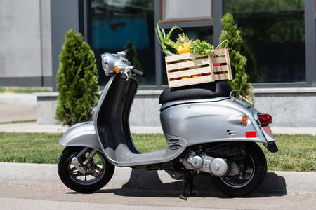 Box with vegetables on scooter outdoorsの写真素材