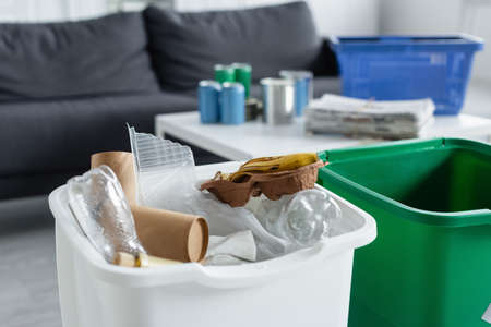 Plastic and paper trash in can at homeの写真素材