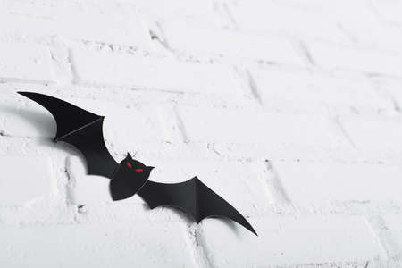 paper cut bat on white brick wallの写真素材