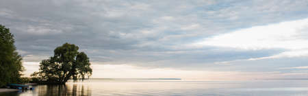 Trees on shore near sea and sky at background, bannerの写真素材