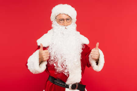 Santa claus in costume showing like gesture isolated on redの写真素材