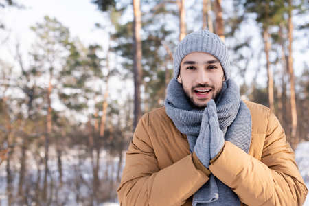Happy man in warm clothes standing outdoorsの写真素材