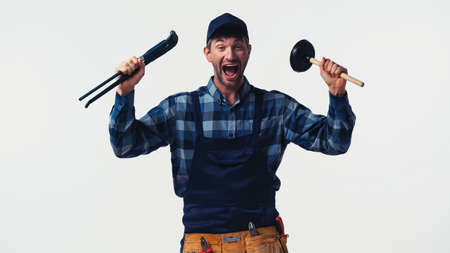 Excited handyman with tools looking at camera isolated on whiteの写真素材