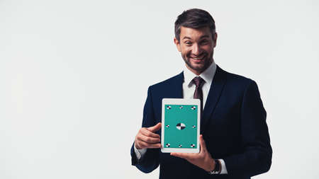 Positive businessman holding digital tablet with chroma key isolated on whiteの写真素材