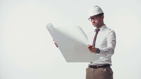 Engineer in shirt and helmet holding blueprint isolated on whiteの写真素材