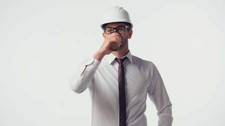 Architect in hardhat drinking coffee to go isolated on whiteの写真素材
