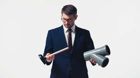 Businessman holding plunger and plastic pipe isolated on whiteの写真素材