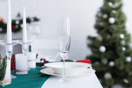 selective focus of champagne glass on table served for christmas dinnerの写真素材
