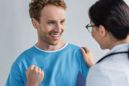 excited patient looking at doctor in glassesの写真素材